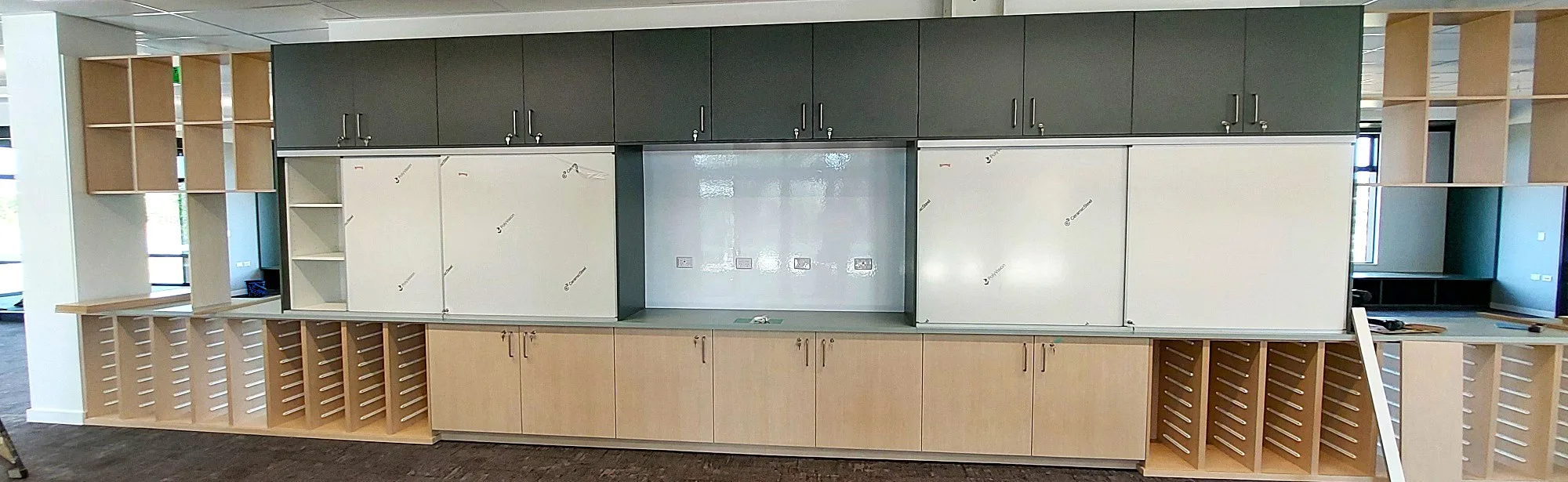 Prowite cabinet mounted sliding whiteboards 2 sets in classroom storage cabinetry with Smart whiteboard wallcovering