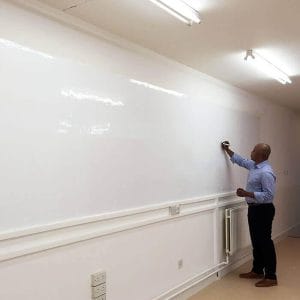 Office wall covered with smart whiteboard wallpaper