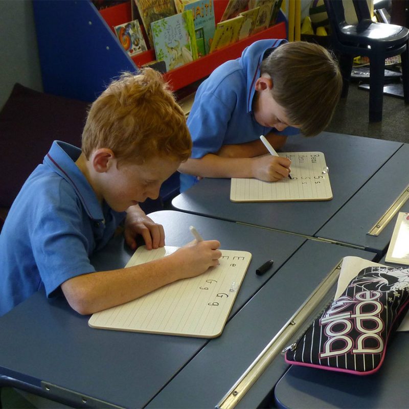 Portable lined note handwriting whiteboards used in classroom