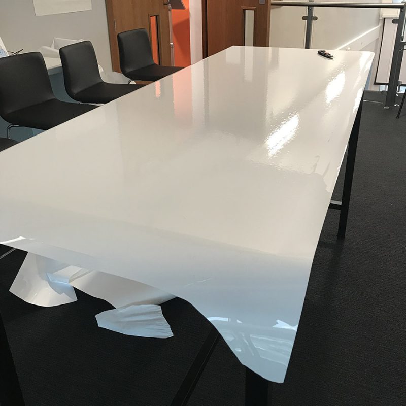 Smart self-adhesive whiteboard film clear applied on office table