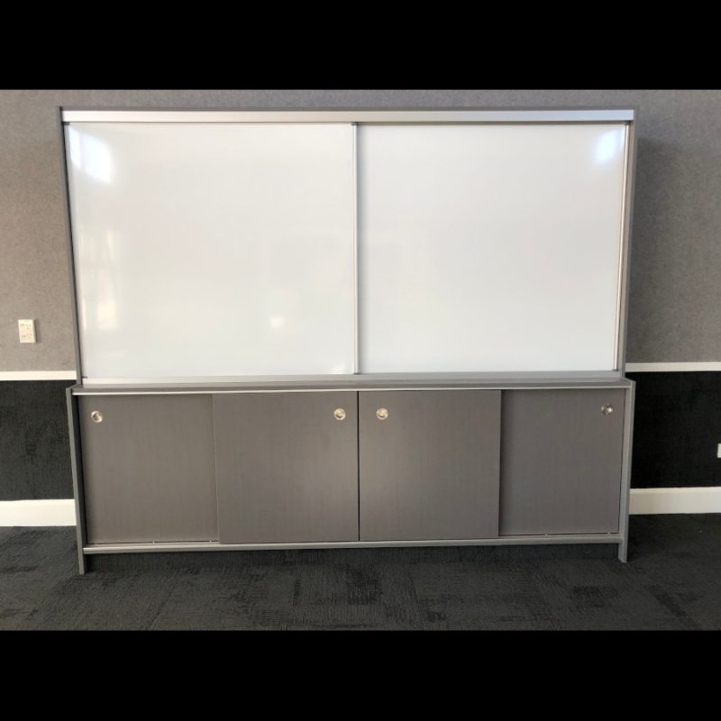 Sliding Whiteboard Cabinet PROWITE™ porcelain magnetic whiteboards with race assembly’s pre-mounted ready to hang on track-Attached: sliding whiteboard system in a classroom.